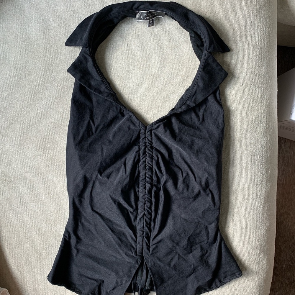 It’s a backless halter top with a collar and scrunch front. Never worn w/o tags.